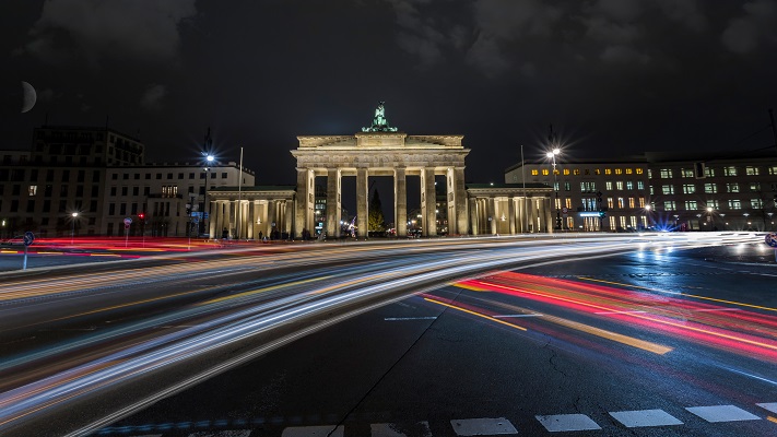 berlin brandenburg gate at night with lights and traffic - germany - ev charger incentives guide - wallbox