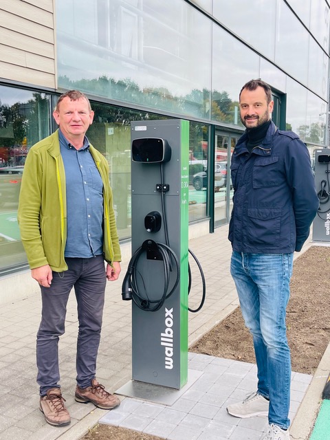 Michel Smeysters and André Thomas installing a Wallbox electric vehicle charger